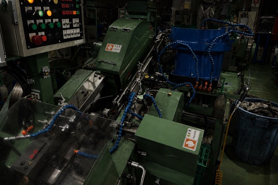 Cold heading machine in a fastener manufacturing plant