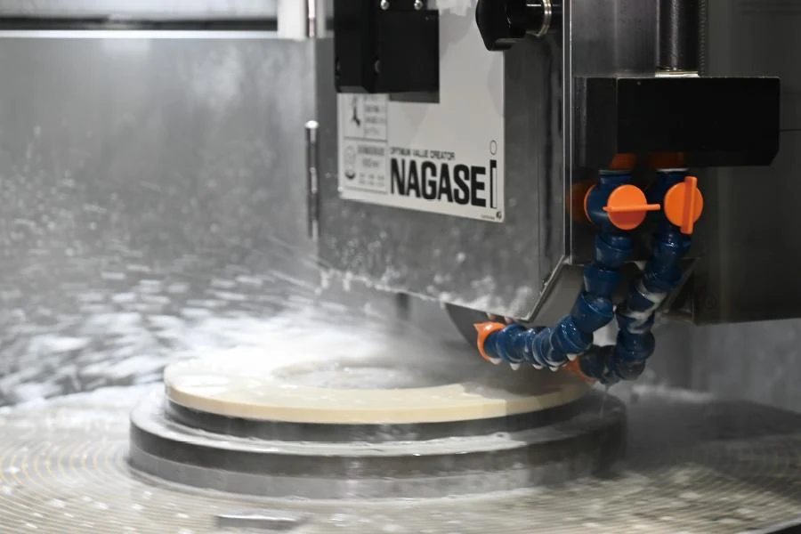 Grinding machine applying coolant to a circular workpiece