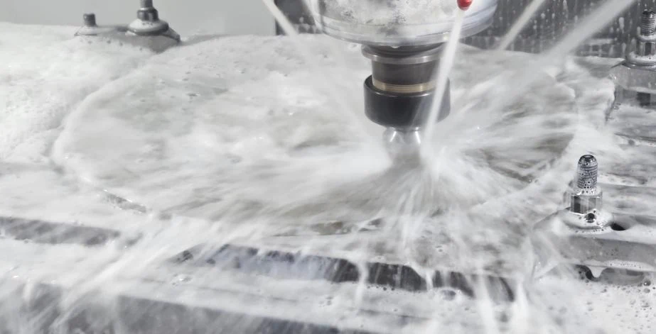 Machining operation with coolant flowing over the work area