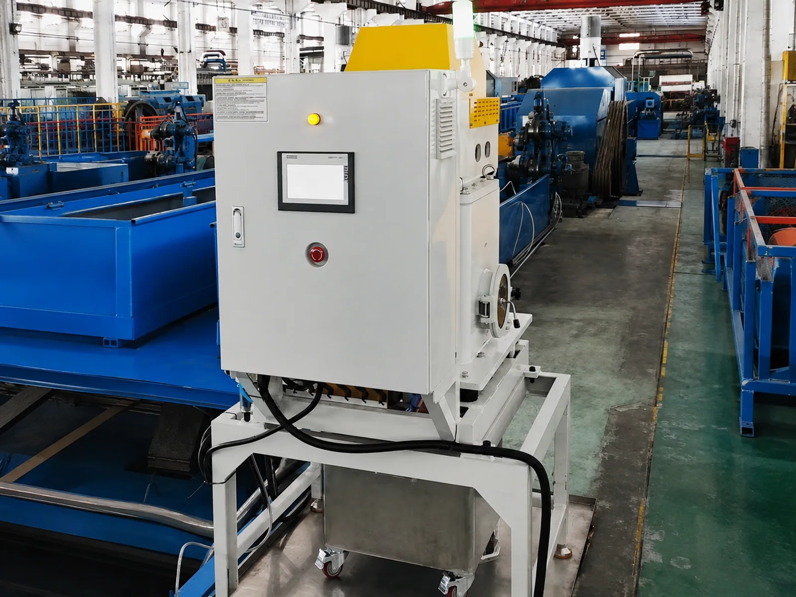Industrial centrifuge beside a factory production line